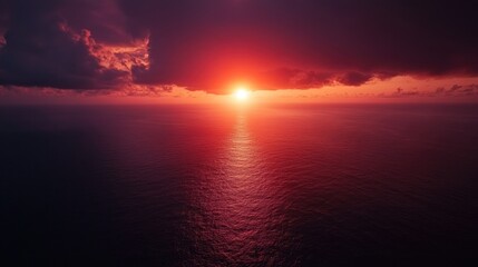 Obraz premium Dramatic Sunset Over Ocean Horizon with Dark Clouds and Vibrant Red Sky