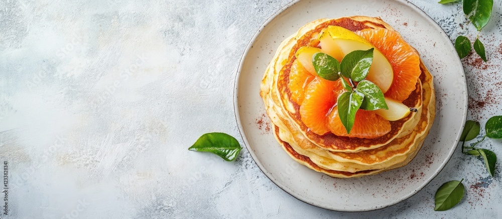 Poster stack of pancakes with fresh fruits including peaches and apples on a beige plate with green leaves 