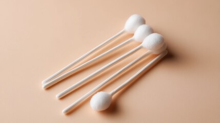 Minimalist Still Life: Four Cotton Swabs on Peach Background