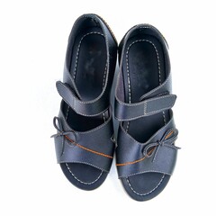 Black wedge shoes with heels and a small bow on them are suitable for fashion on white background