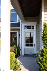 Elegant Home Exterior: Modern House with Green Landscaping and White Front Door