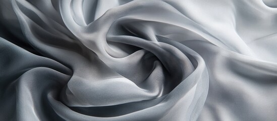 Fototapeta premium Silky gray fabric texture with smooth folds and wrinkles suitable for background design. Copy Space available for text placement.