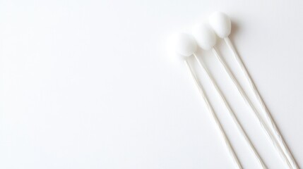 Cotton buds arranged on a clean surface for ear cleaning with ample space for text or branding on a white background