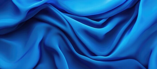 Obraz premium Smooth blue silk fabric texture with intricate folds and waves ideal for background design Copy Space