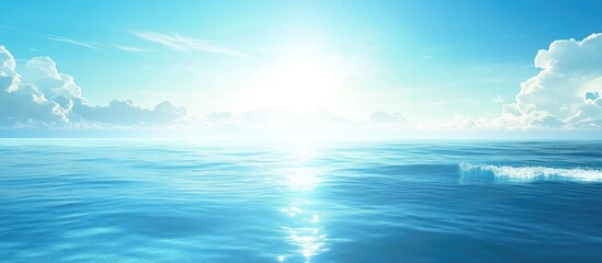 Vast ocean landscape under bright sunlight with clear blue skies and soft clouds Copy Space