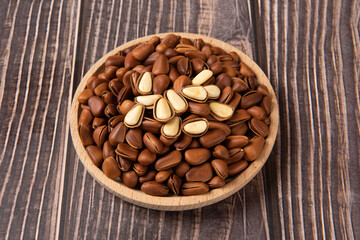 roasted pine nuts food on wooden table.