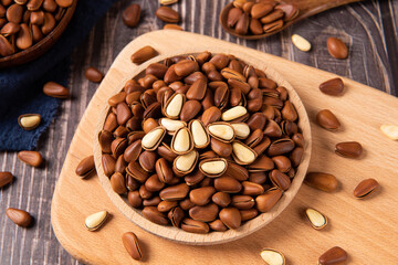 roasted pine nuts food on wooden table.