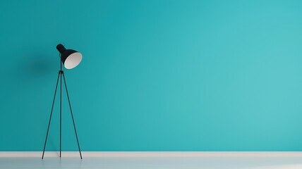 A modern floor lamp stands against a vibrant turquoise wall, adding a stylish touch to a minimalist interior space.