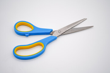 Stainless steel scissors with blue and yellow handles