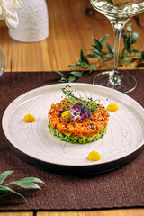 Portion of gourmet salmon tartare with chopped avocado and sauce