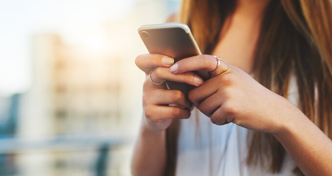 Woman, hands and phone for typing in city, vacation tourist and online for social media update. Female person, urban location and internet for guidance on travel, texting and app for message on trip