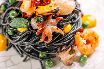 Portion of gourmet black squid ink pasta with seafood