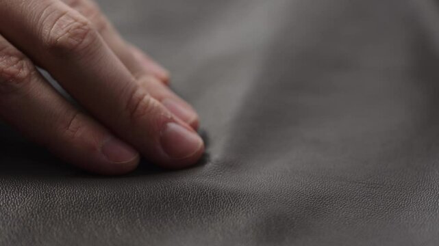 Slide shot man touching fine leather closeup