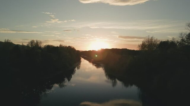 Calm river at sunset reflecting the golden hour light