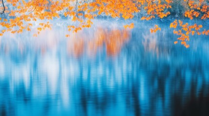 Vibrant orange autumn leaves reflect on serene blue water, blending seasonal charm with tranquil beauty.