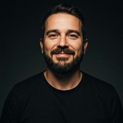 Fototapeta premium Confident Bearded Man Smiling in Dark Studio Portrait, Perfect for Professional Headshots and Personal Branding