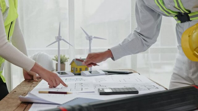 Close up of hands working brainstorming about design architectural and engineering for houses and buildings then handshake.