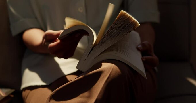 An individual perusing a resource book in the library.