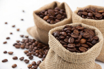 Fototapeta premium Roasted coffee beans in a sack on a white background
