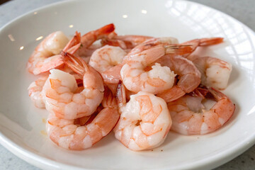 Several boiled shrimps in a white plate