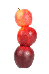 three apples placed on a clean white background. The apples are fresh, with smooth, shiny skin