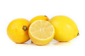 A whole lemon and a halved lemon placed on a white background