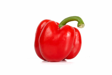 A fresh, glossy red bell pepper isolated on a white background