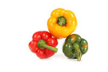 A trio of fresh bell peppers green, red, and yellow isolated on  white background