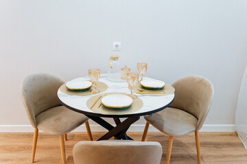A beautifully arranged dining table set, complete with meticulously placed plates and elegant...
