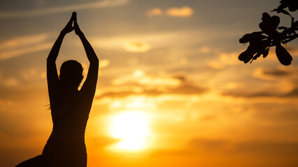 Silhouette lifestyle woman yoga exercise and worm up raise arm before pose for healthy life.  Young girl or people pose balance body vital zen and meditation workout and fitness sport outdoor sunset