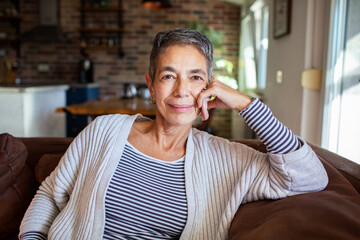 Portrait of a senior woman relaxing on couch at home