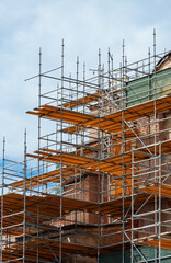 scaffolding around the dome of the mosque, against the sky, to repair the exterior of buildings, or on a construction site