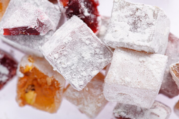 Sweet food Turkish delight, assorted rahat locum in form of cubes with nuts and powdered sugar, traditional food, on white background