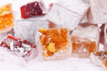 Sweet food Turkish delight, assorted rahat locum in form of cubes with nuts and powdered sugar, traditional food, on white background