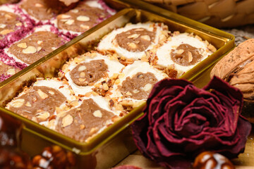 Sweet food Turkish delight and red rose on wooden background, assorted locum and candy for decorated backdrop