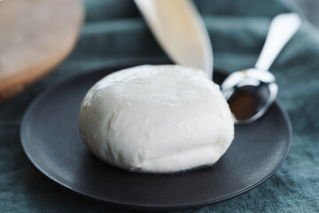 mozzarella ball on small ceramic plate