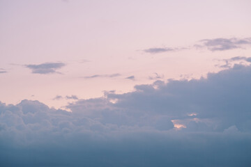 Evening clouds in the sky in summer evening with warm light