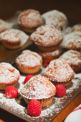 Fresh cupcake sprinkled with powdered sugar. Homemade cupcakes with raspberries. Photo