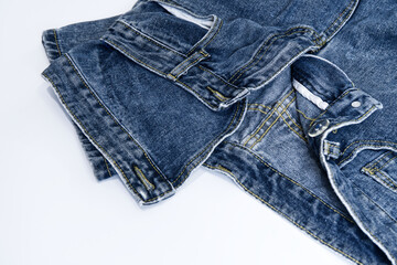 Denim jeans on a white background. Close-up denim jeans texture with stitching details for vintage fashion, pants, cloth texture, stylish, and textile concepts. Abstract background of jeans on white.