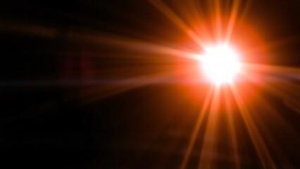 Bright Orange Sunburst Lens Flare on Black Background