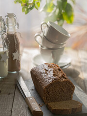 Cholocate sponge cake snack in a rustic atmosphere accompanied by a chocolate and milk drink