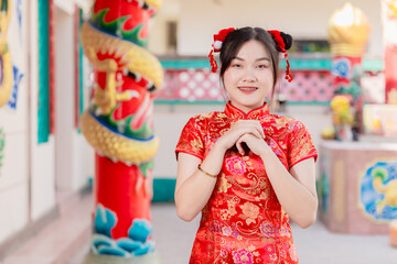 Asian Chinese women praying at shrine, pay homage fortune in Chinese New Year festival activity