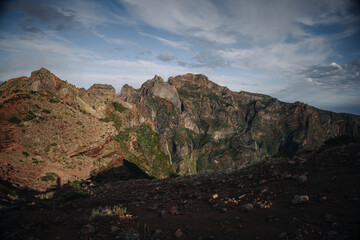 Breathtaking view of a mountainous landscape captured during early evening, highlighting dramatic rock formations and a vast expanse of sky.