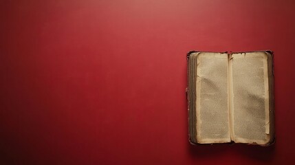 Antique book open on red background, space for text, vintage feel, history concept