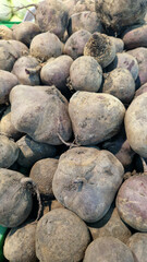 Beets for sale in a supermarket. Ripe beets close-up with selective focus. Vegetables. A pile of beets for sale in a store. A variety of fresh vegetables on a supermarket counter