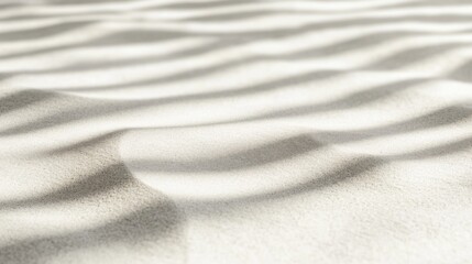 Obraz premium Close-up of textured sand with wave patterns and light shadows.