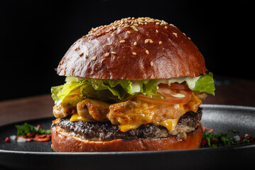 A delicious, gourmet burger featuring a grilled patty, melted cheddar cheese, crispy chicken, fresh lettuce, tomato, and mayo, all nestled in a toasted sesame seed bun. Perfect for food lovers.