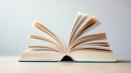open book with pages fanned out, showcasing its textured paper and soft cover.