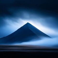 Fototapeta premium Dark Blue Mountain Peak in Fog