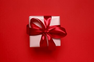 Beautiful gift box on red background